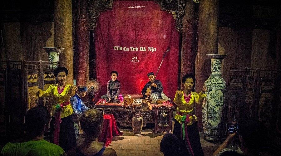Traditional Vietnamese cultural performance taking place in a historic building in Hanoi Old Quarter