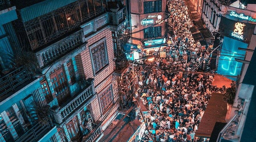 Aerial view of Hanoi Old Quarter at night showing bright lights of clubs and bars