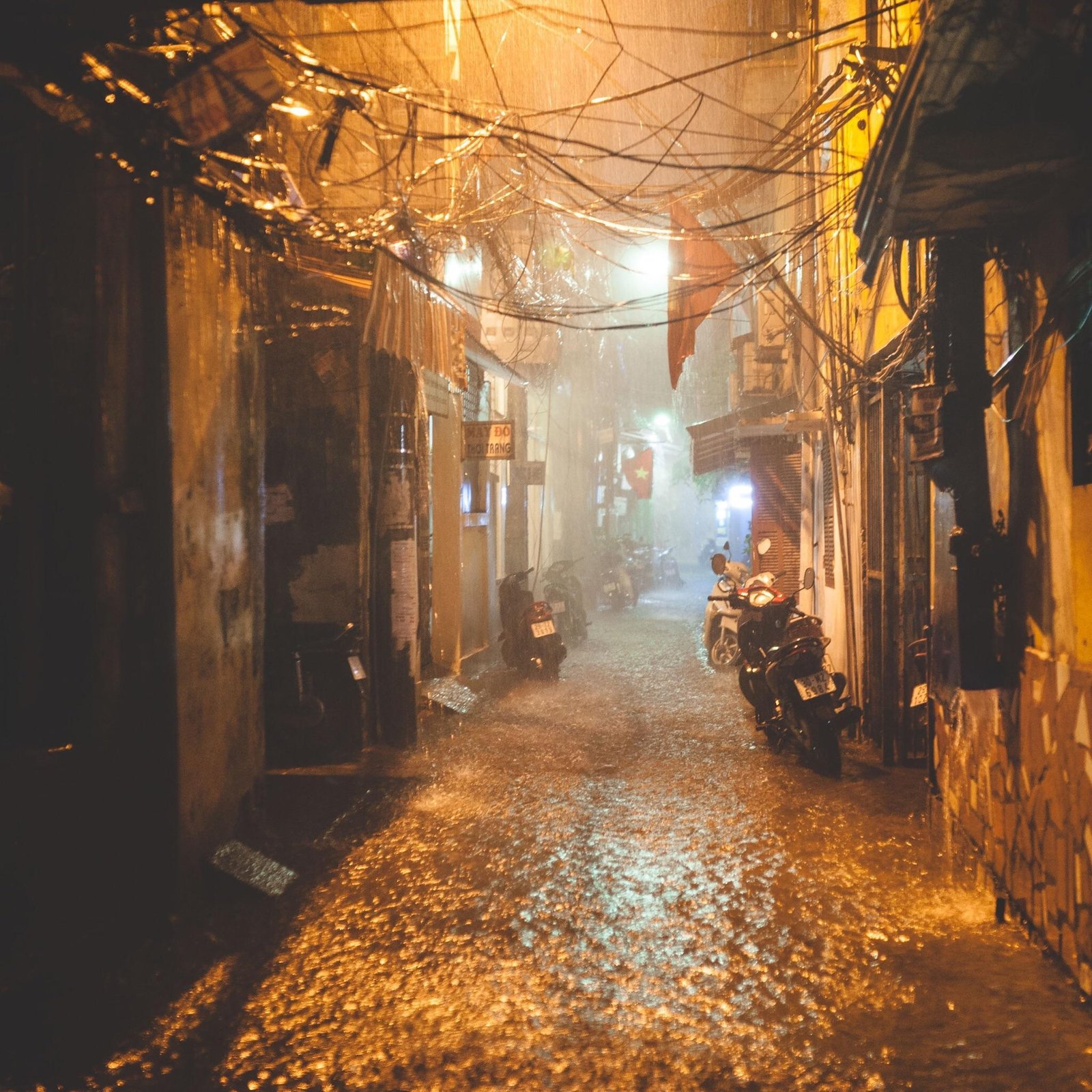 Atmospheric scene of Hanoi Old Quarter streets during a light rain