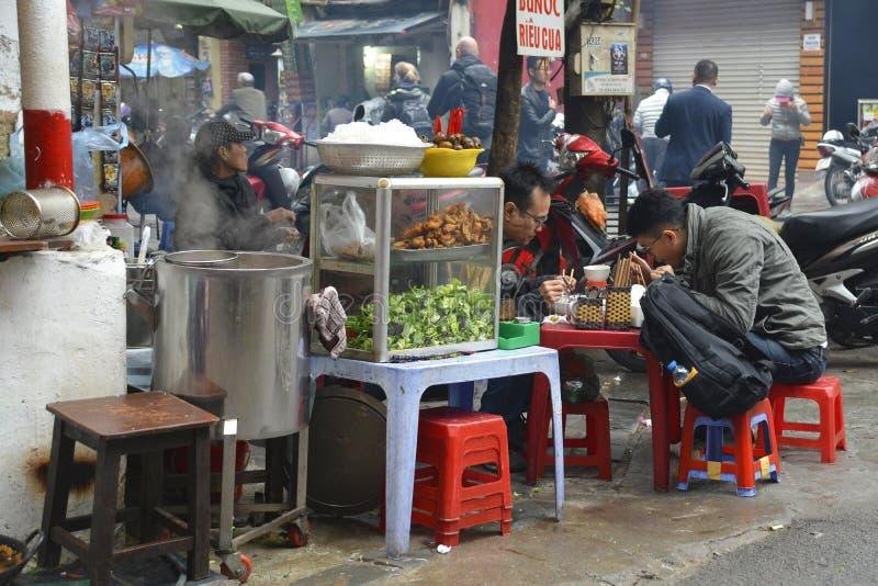 Busy street vendors in Hanoi's Old Quarter selling local food