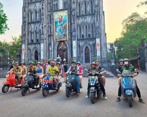 Tourists prepared for vespa tour during rainy season in Hanoi