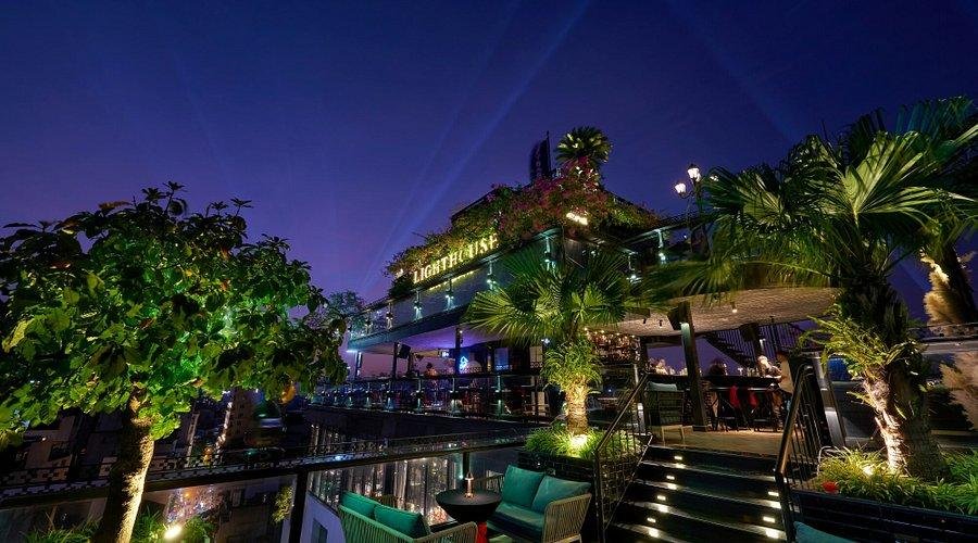 Blue hour photography from a Hanoi rooftop bar showing city lights