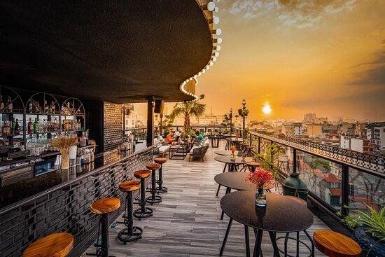 Golden hour sunset view from a Hanoi Old Quarter rooftop bar
