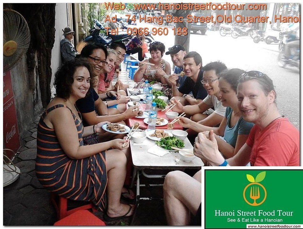 People eating at street food stalls in Hanoi Old Quarter