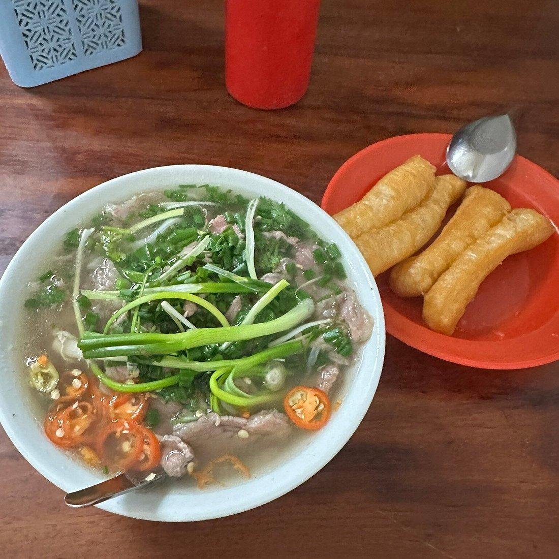 Authentic pho bowls being served at a local street food stall in Hanoi