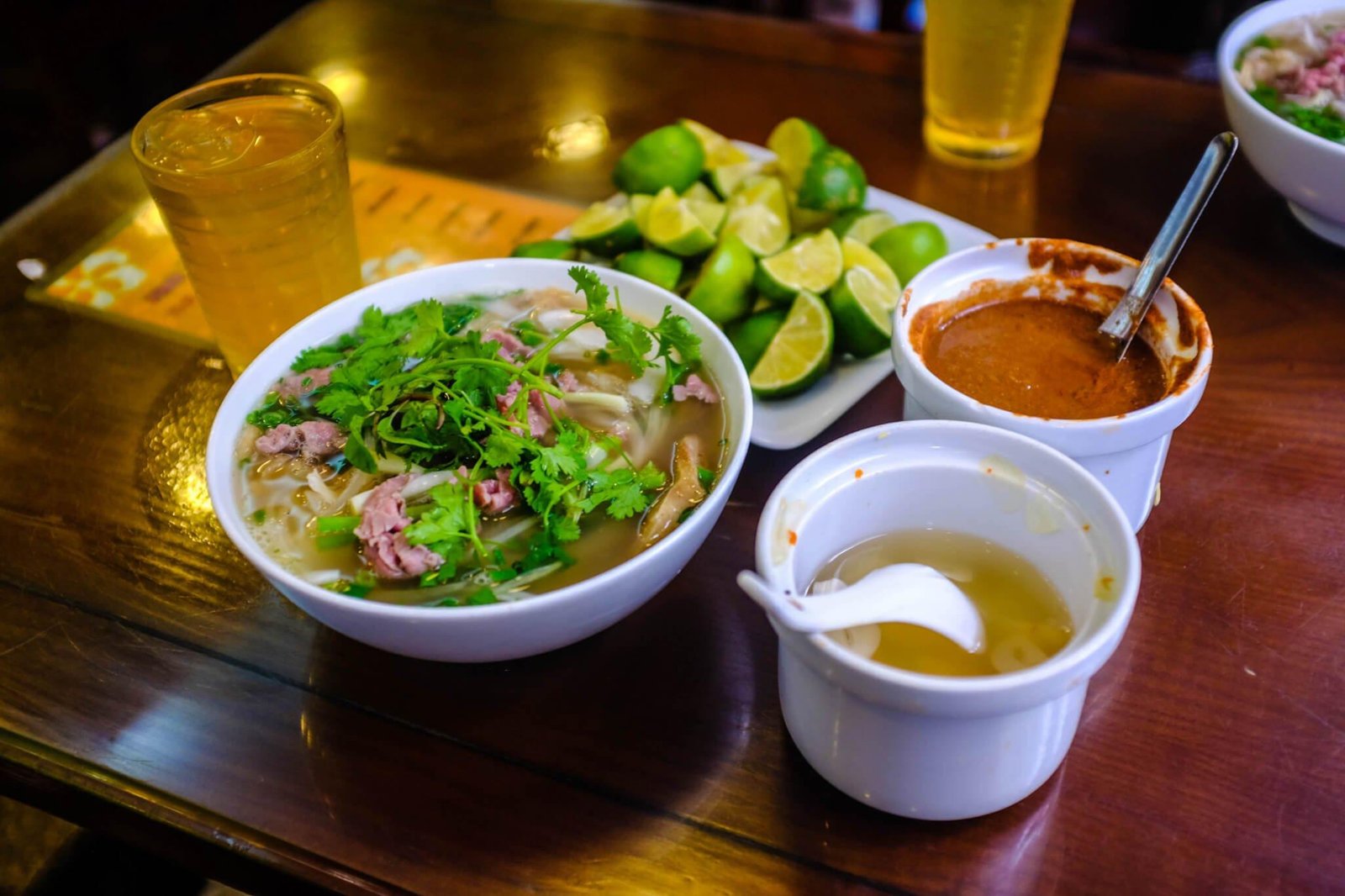 Steaming bowl of traditional Pho being served at a street stall in Hanoi Old Quarter