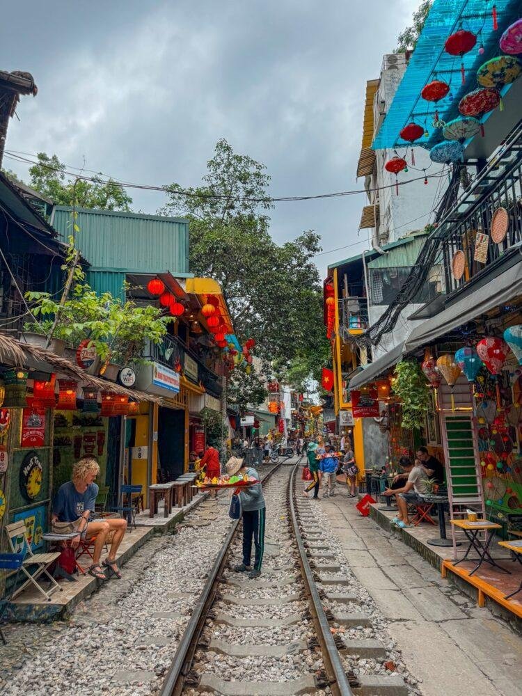 Café on Hanoi Train Street with railway tracks running through the narrow street