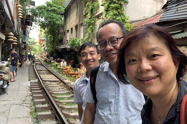 Tour guide explaining safety measures to tourists on Train Street