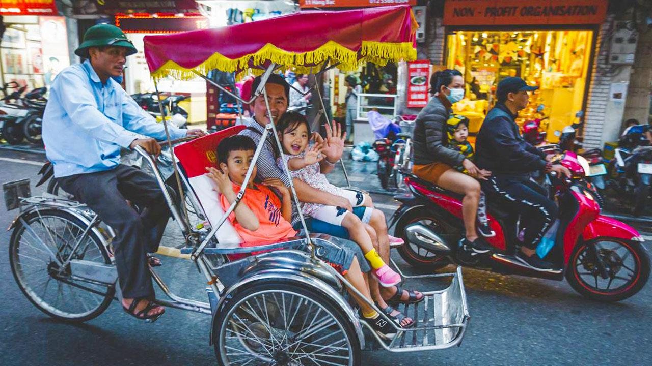 Various transportation methods in Hanoi including walking, cyclo, and motorbike