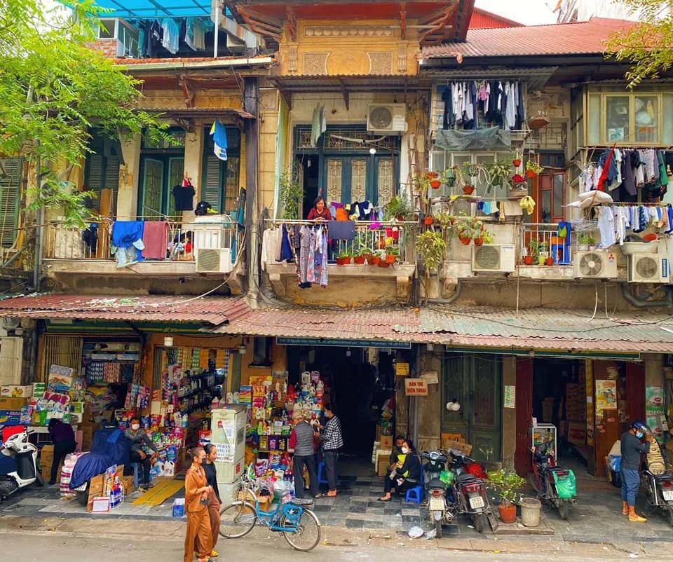 Detailed view of traditional tube house facades in Hanoi Old Quarter showing their narrow width and vertical development