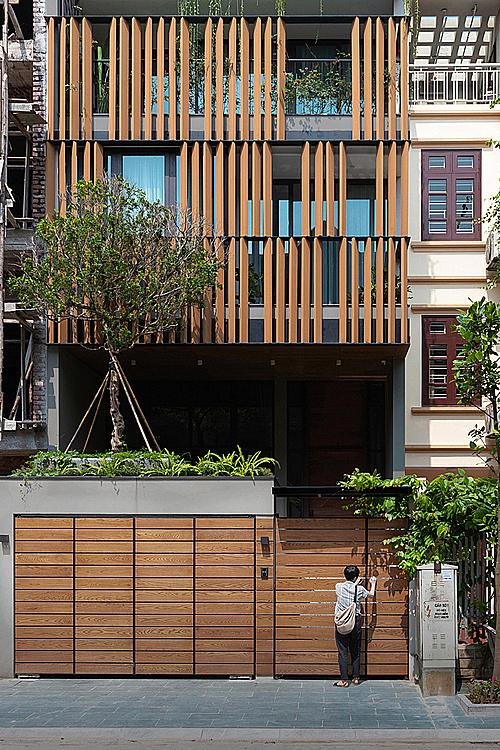 Interior courtyard of a traditional Hanoi tube house showing wooden beams and natural light
