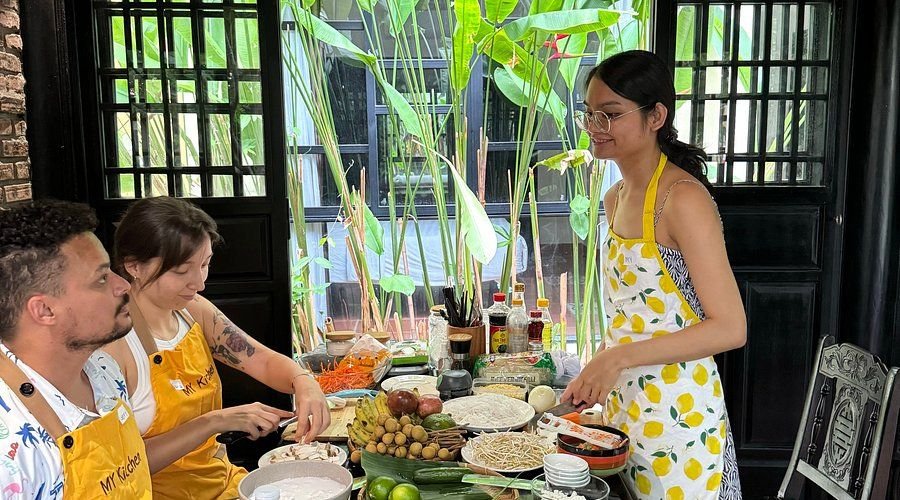 Travelers participating in a hands-on vegetarian Vietnamese cooking class