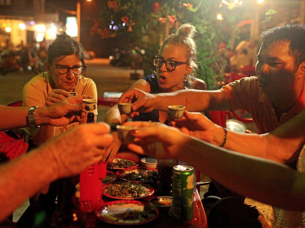 Group of tourists enjoying food on Vespa tour