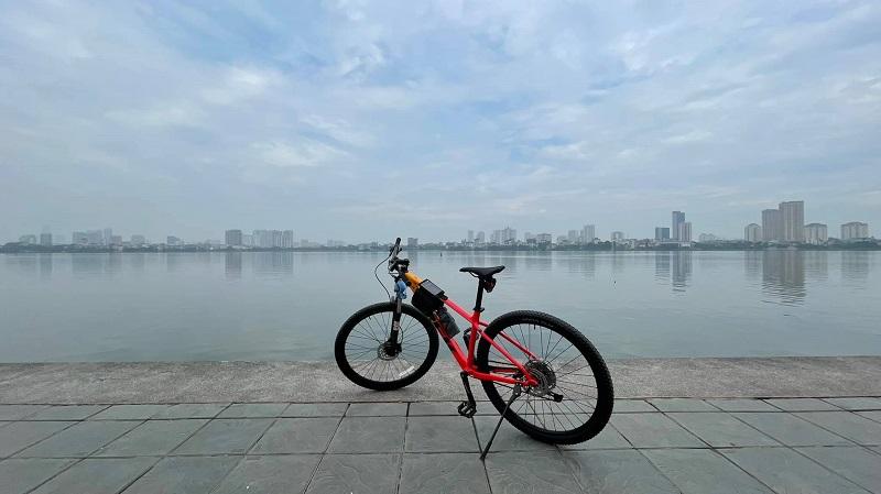 Tourist cycling around West Lake in Hanoi