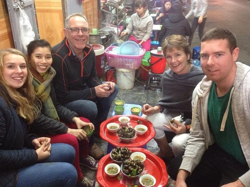Happy family completing their Hanoi food tour experience
