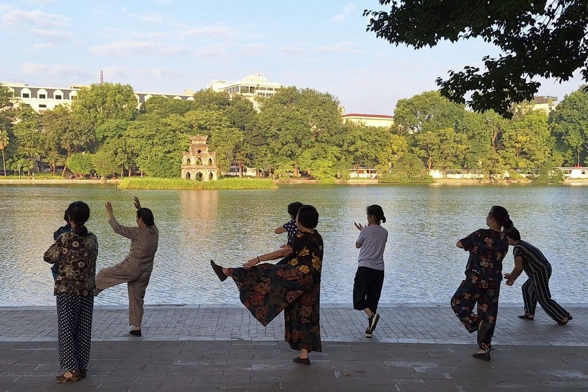 Morning tai chi practice at Hoan Kiem Lake with locals exercising