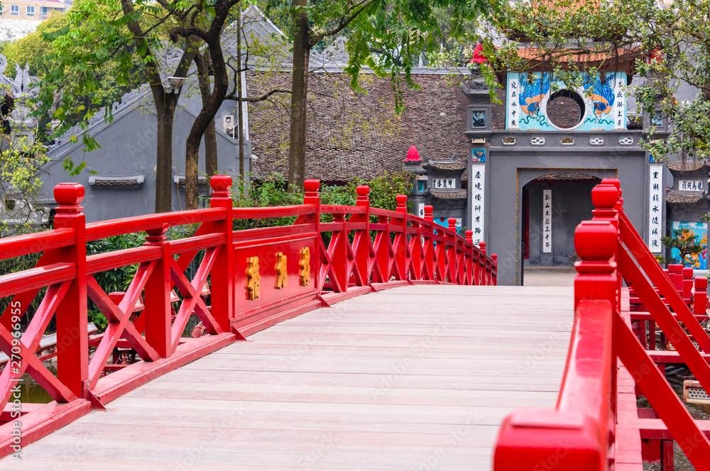The iconic red Huc Bridge at Hoan Kiem Lake leading to Ngoc Son Temple
