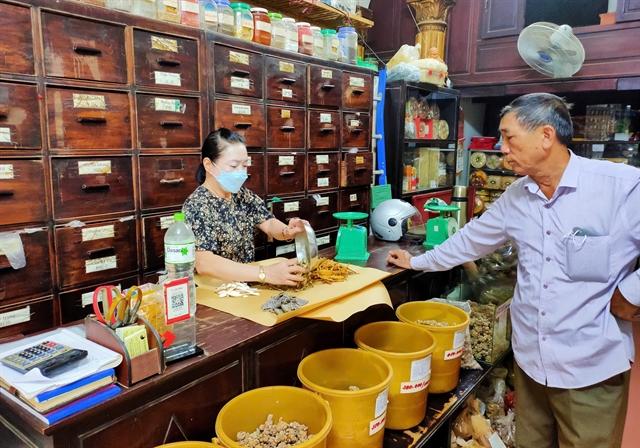 Traditional medicine shop on Lan Ong Street with dried herbs and ingredients displayed