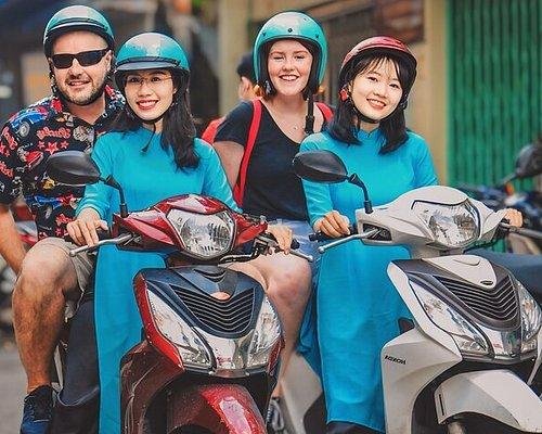 Local Vietnamese guide on Vespa with tourists