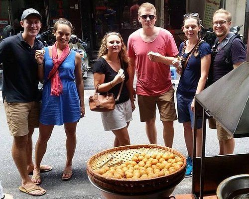 Private luxury food tour guide explaining Vietnamese cuisine in Hanoi