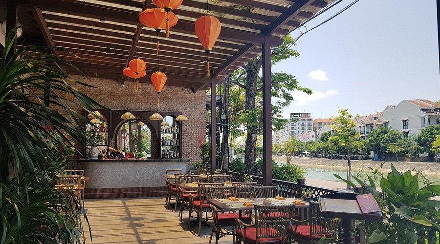 Atmospheric evening dining scene in Hanoi Old Quarter with lanterns and outdoor seating