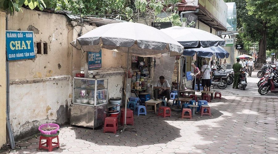 Street food vendors in Hanoi Old Quarter serving vegetarian dishes