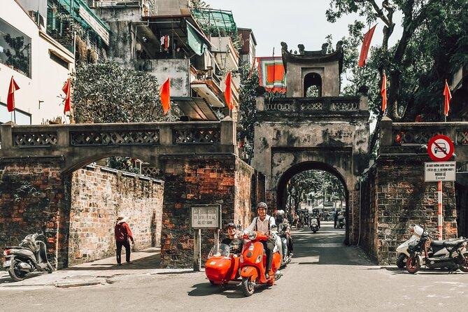 Vespa riding through Hanoi Old Quarter narrow streets