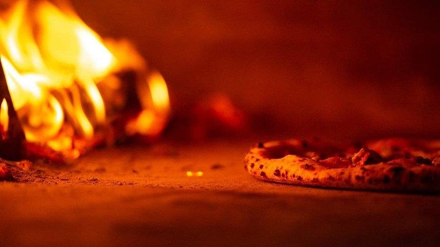 Modern pizza restaurant in Hanoi Old Quarter with wood-fired oven