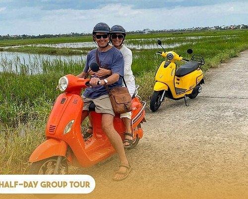 Professional Vespa tour operator with safety equipment and well-maintained scooters