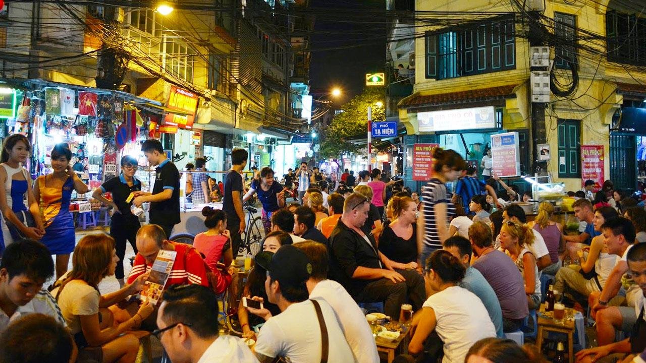 Ta Hien Beer Street at night with tourists enjoying local brews