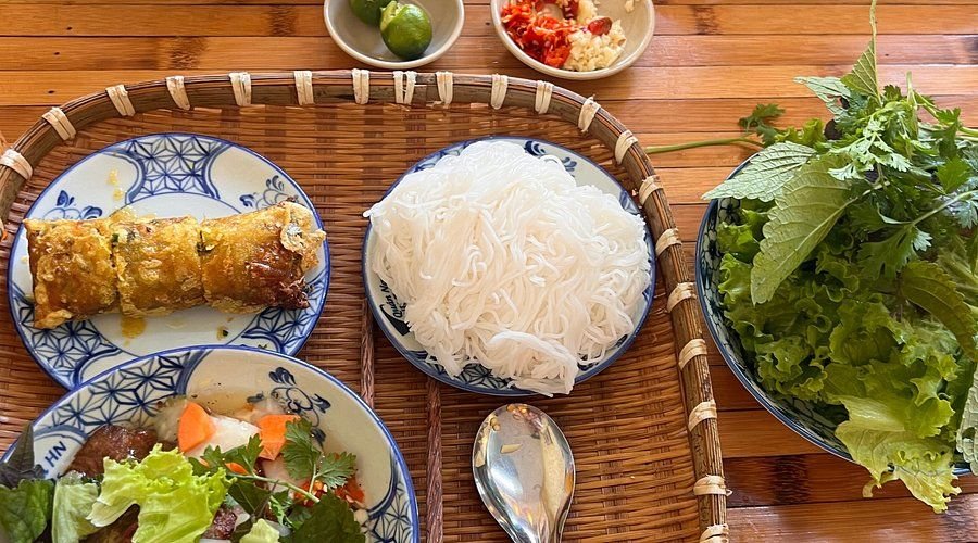 Array of traditional Vietnamese dishes including pho, bun cha, and banh mi