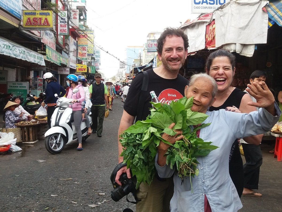 Travelers enjoying a guided food tour in Vietnam with local guide