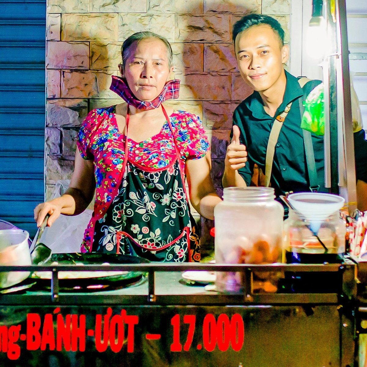 Vietnamese street food vendors preparing traditional dishes
