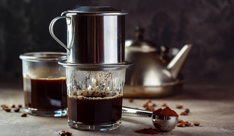 Traditional Vietnamese drip coffee being prepared with a phin filter