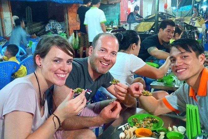 Small group enjoying a guided street food tour in Vietnam