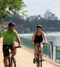 Cyclists riding along the peaceful West Lake route in early morning