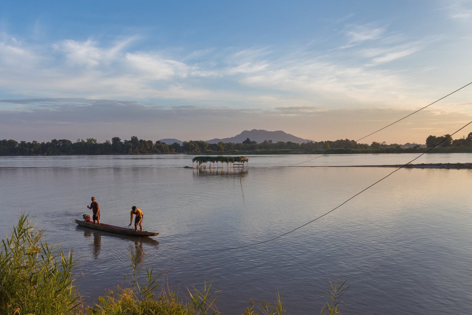Group of travelers enjoying a Mekong river sunset together