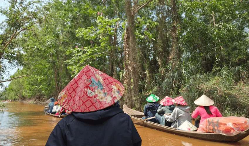 Traditional boat cruise through palm-lined canals in the Mekong Delta Vietnam