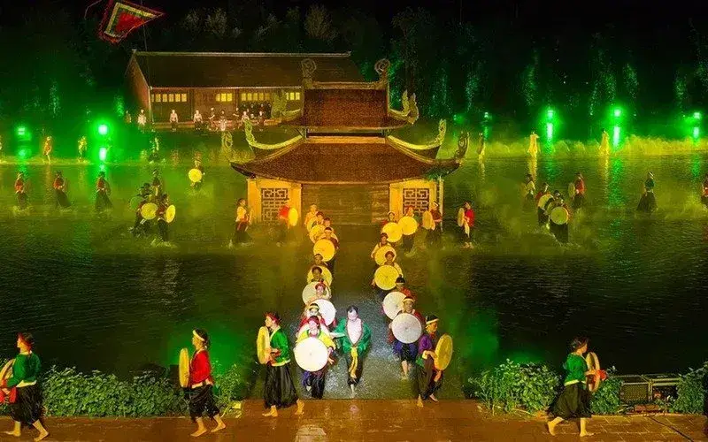 Large outdoor cultural performance near Hanoi with dancers and illuminated scenery