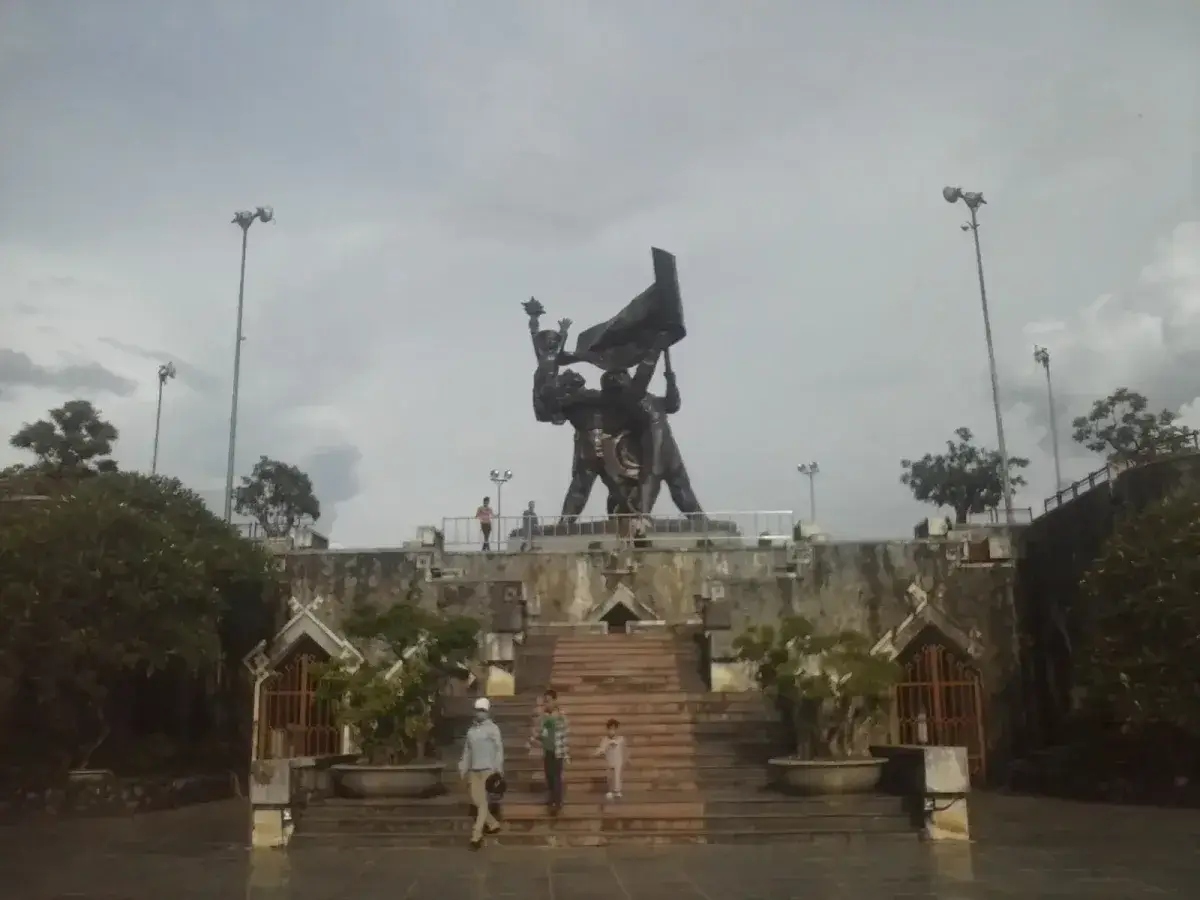 Dien Bien Phu Victory Monument seen from across the green hillside