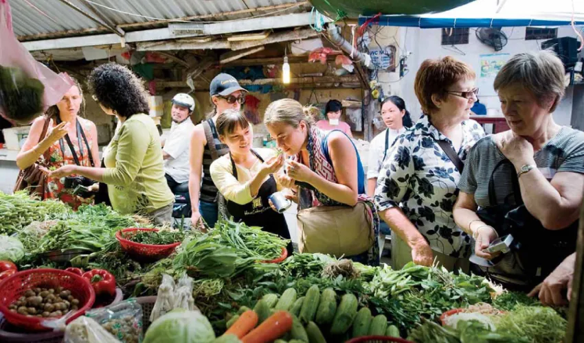 Tourists get to experience going to the market to buy ingredients