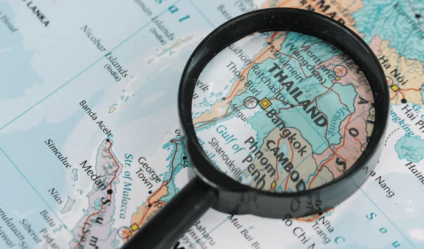 Thailand itinerary planning with a map and magnifying glass