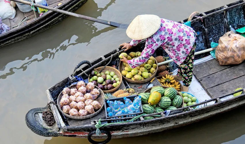 Fruit vendor at a floating market in Can Tho on a Vietnam culinary tour
