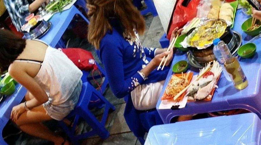 Colorful night market in Hanoi with various food stalls illuminated